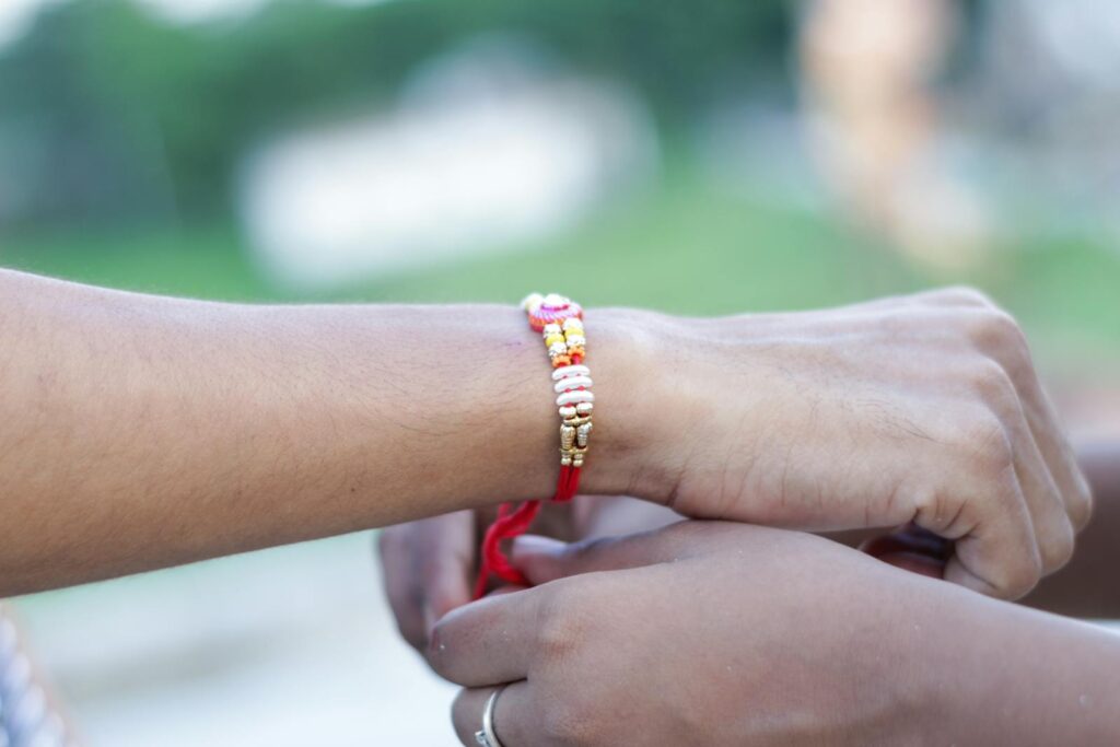 A close-up image capturing the Rakhi tying tradition, symbolizing love and protection.