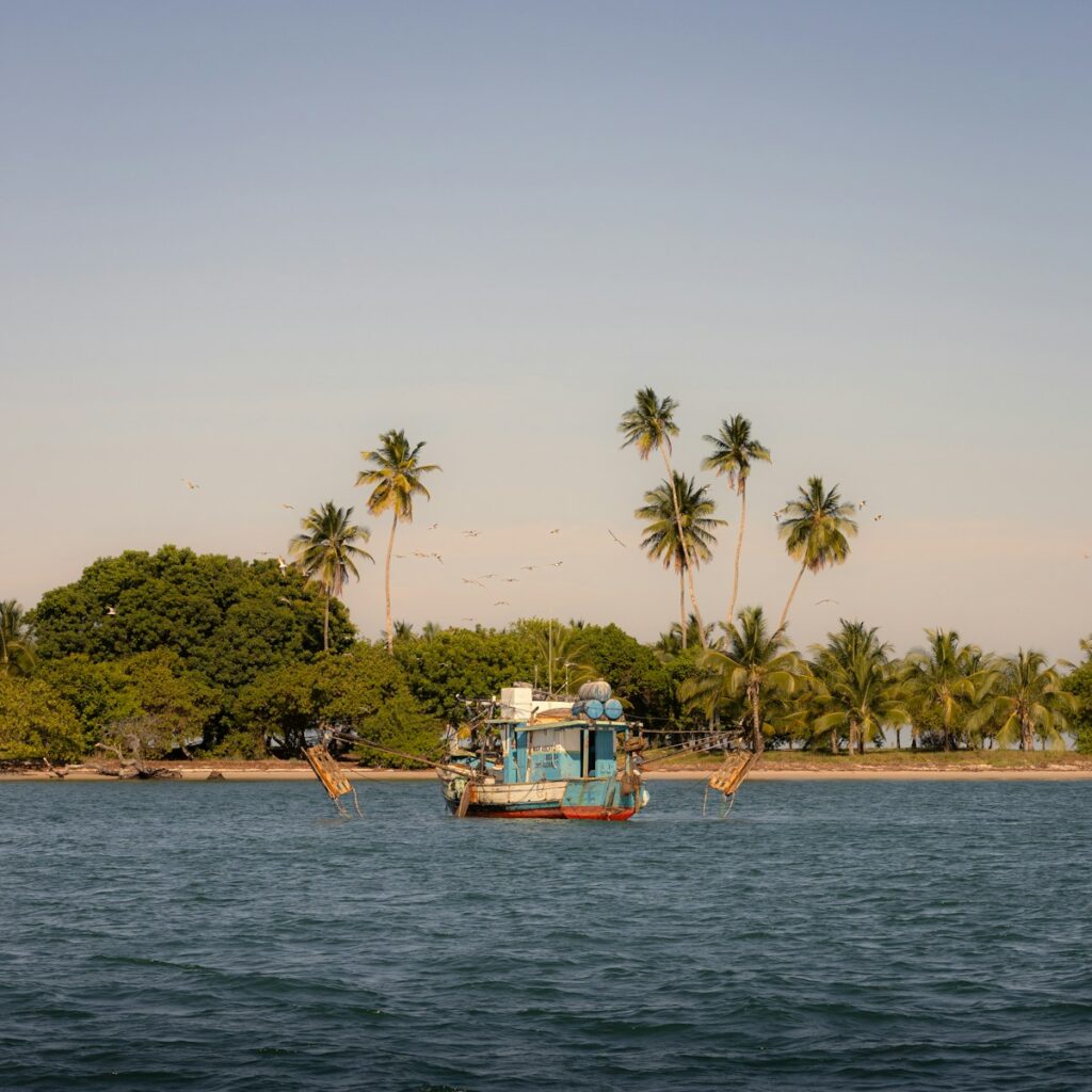 A boat floating on top of a large body of water