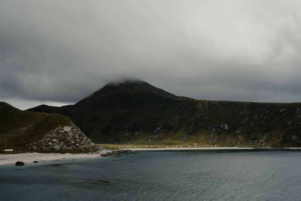 a body of water with mountains in the back